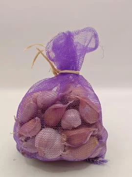 Garlic in a bag on a white background Stock Photos