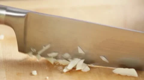 Garlic being finely chopped Stock-Footage 24664361