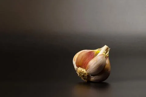 Garlic on a black background with copy space. Stock Photos