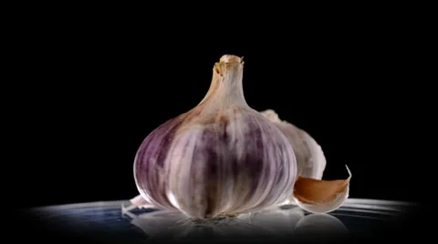 Garlic on black background Stock Footage