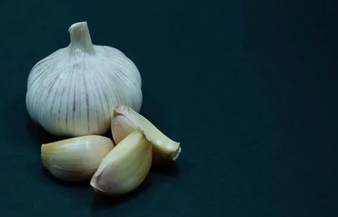 Garlic on black background Stock Photos