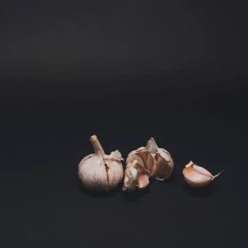 Garlic on black table 스톡 사진