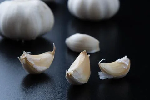 Garlic on black table Stock Photos