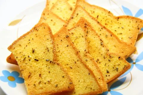 Garlic bread with herbs, on white bread dish Stock Photos