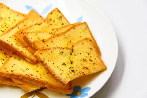 Garlic bread with herbs, on white bread dish Stock Photos