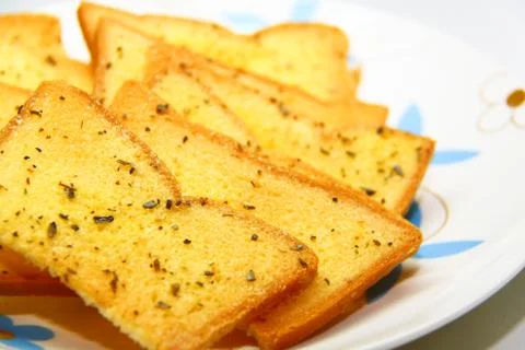 Garlic bread with herbs, on white bread dish Stock Photos