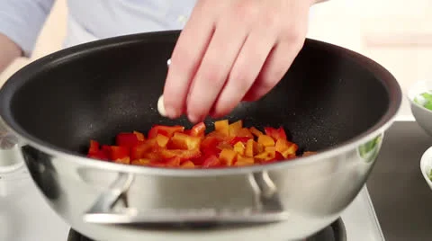 Garlic, broccoli and spring onions being added to a pan Stock Footage 24704501