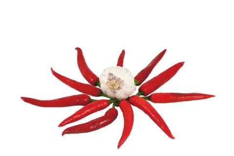 Garlic bulb in centre of circular red cihilli display Stock Photos