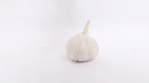 Garlic bulb falls on white background in slow motion Stock Footage 86323514