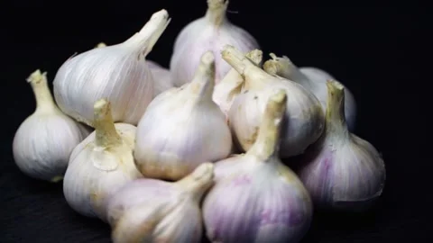 Garlic bulbs close-up rotate in a circle. Stock Footage 249273318