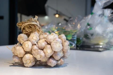 Garlic Bundle in studio light on the white marble surface table, prepare fo.. Stock Photos