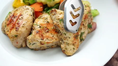 Garlic chicken thighs pieces serving on plate. Real time Close-up Video stock 286072340