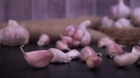 Garlic clove falling on black background Video stock 232415340