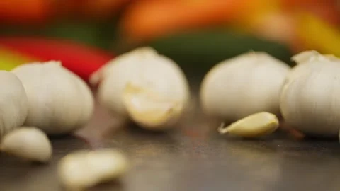 Garlic cloves falling on a beautiful background of vegetables. Stock Footage 296362506
