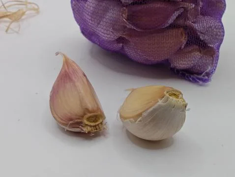 Garlic cloves on a white background macro photography Stock Photos