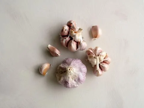 Garlic flat lay composition on neutral textured background Stock Photos