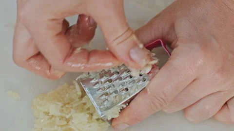 Garlic grating outdoors. Rustic outdoor kitchen with garlic being grated Stock Footage 332291183
