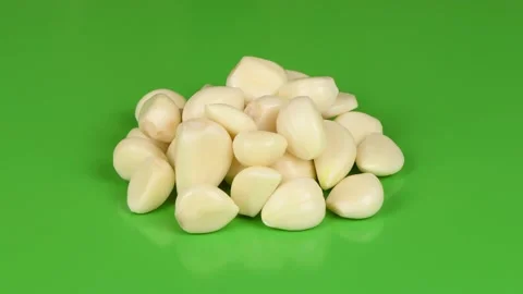 Garlic on green background. Side view. Loop motion. Stock Footage 163917415