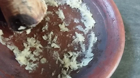 Garlic that has been crushed using traditional Indonesian tools Stock Footage 226731790