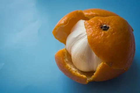 Garlic instead of a mandarin. Stock Photos