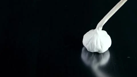  Garlic isolated on black background Stock Footage 132910575