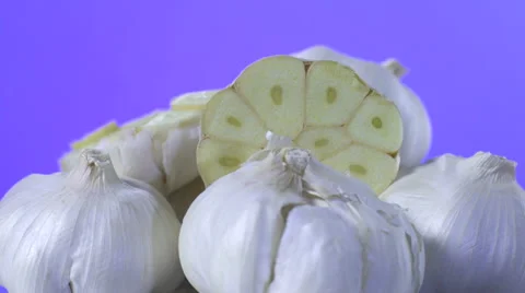 Garlic isolated rotating on purple background Video stock 62333574