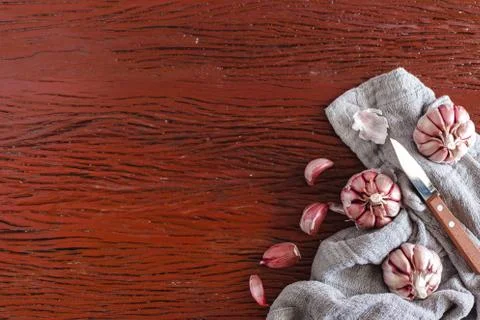 Garlic with knife on a wood surface Stock Photos