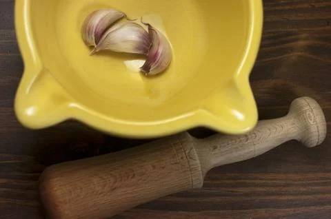 Garlic, mortar, kitchen Stock Photos