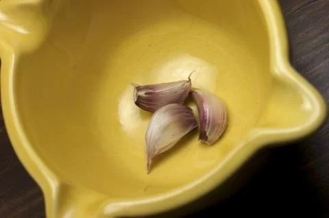 Garlic, mortar Stock Photos