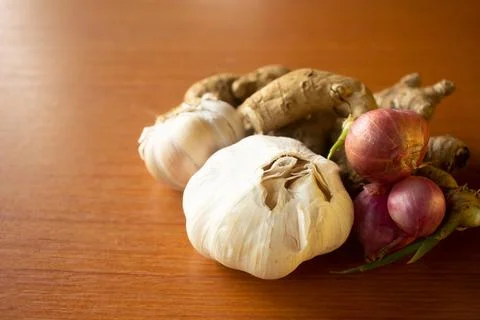 Garlic, onion and ginger placed on the table are brown Stock Photos