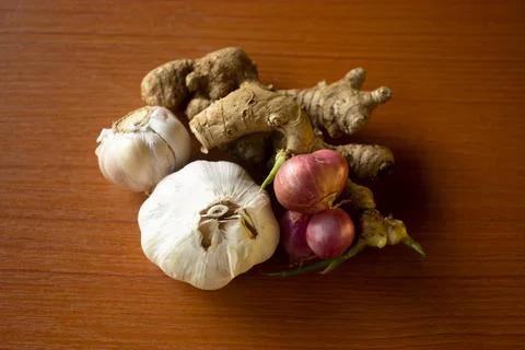 Garlic, onion and ginger placed on the table are brown Stock Photos