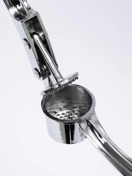 Garlic press cup and hinge close up Stock Photos