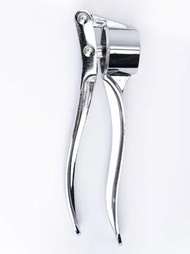Garlic press with press cup close up Stock Photos
