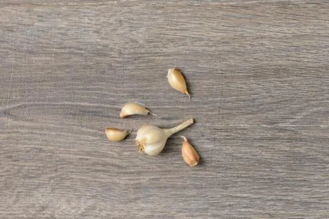 Garlic scattered on wooden table Stock Photos