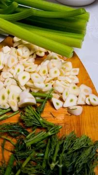 Garlic sliced on a Board with dill celery, close-up, background,  space copy, Stock Photos