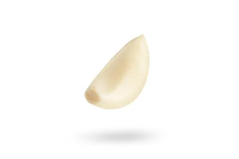 Garlic on a white background. Falling peeled clove of garlic falling on white Stock Photos