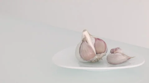 Garlic on a white plate Stock Footage 34423593