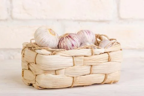 Garlic in a wicker basket Stock Photos