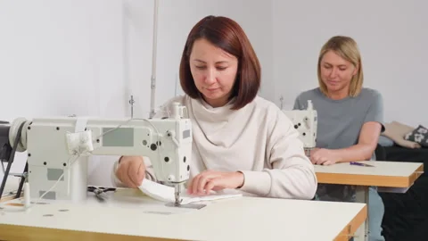 Garment Designers Sewing In Workshop Demonstrating Skill Collaboration And Focus Видео 307137492
