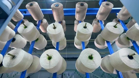 Garment factory production equipment. White threads are forming fabric while Stock Footage