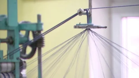 Garment manufacturing, with multi-colored coils coming off the thread Stock Footage 82659034
