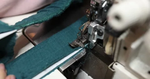 Garment worker operates overstitching ma... | Stock Video | Pond5