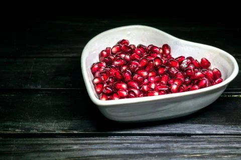 Garnet in dish on black Stock Photos