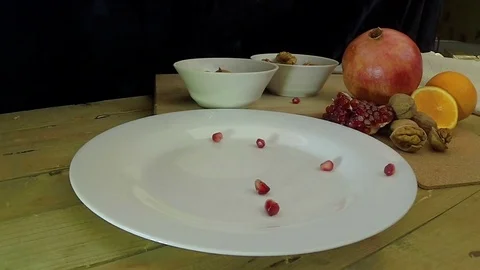 Garnet falls on the plate slow motion Stock Footage 77484490