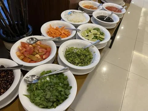 Garnish set featuring vegetable, sauce and lime Фото