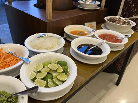 Garnish set featuring vegetable, sauce and lime Stock Photos