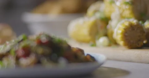 Garnished Herb Chilli Onion Mayo Loaded Stack of Corn on the Cob Focus Pull Video stock 161963886