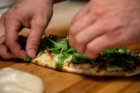 Garnishing a Flat Bread Pizza Stock Photos