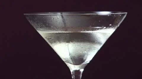 Garnishing Martini with an olive Stock Footage 24633709