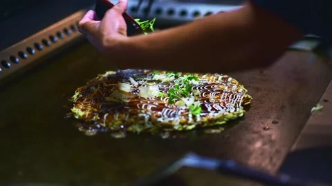 Garnishing Okonomiyaki, Japanese cabbage Potato Latkes Stock Footage